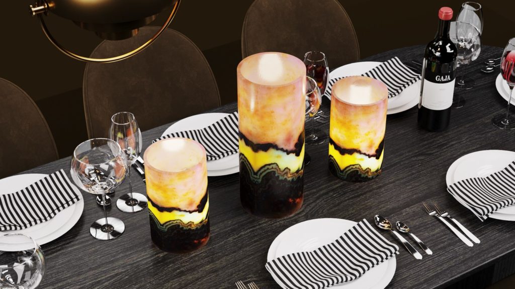 Three small-sized onyx table lamps of cylindrical shape standing on the served dinner table