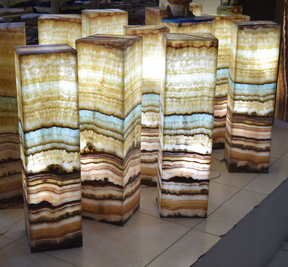 A dozen of rectangular onyx floor lamps standing next to each other made from Serpentina Beta Azul stone collection with blue betas.