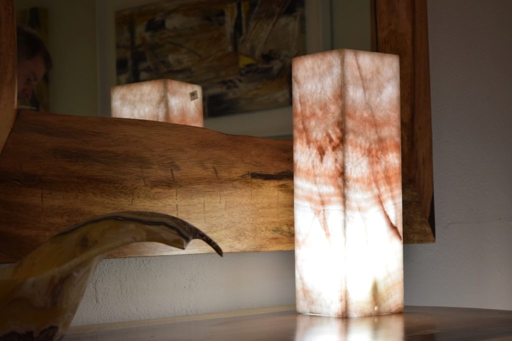 Onyx Rosa Cristal table lamp standing on the nightstand next to the mirror with light on.