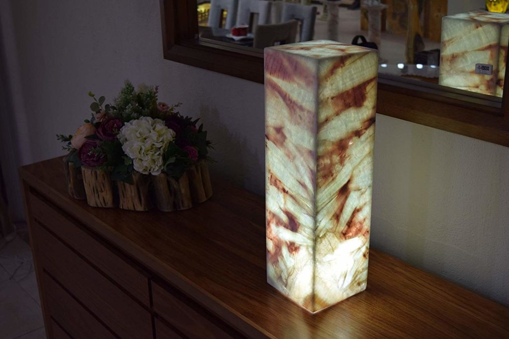 Midsize rectangular table lamp made of Azulita stone standing next to the mirror on the table