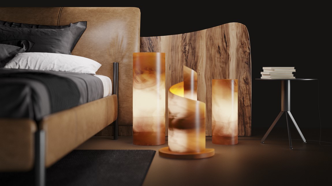 three onyx floor lamps from onyx miel collection standing next to the bed - two cylindrical floor lamps and one is snail- or spiral-shaped lamp