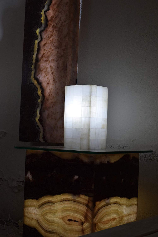 Onyx small-sized rectangular lamp made from Blanco San Luis stone collection standing on the night table with light on