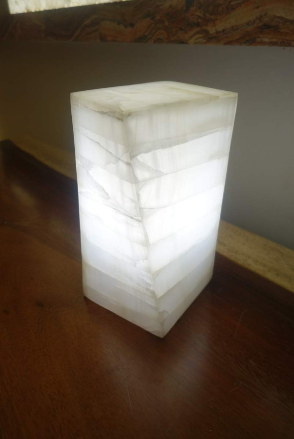 Small-sized twisted onyx table lamp of white color made from Blanco San Luis stone collection