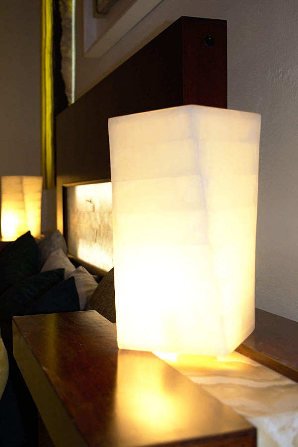 Two twisted onyx table lamps made from Blanco San Luis stone with light on